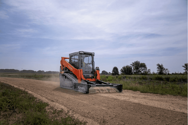 Track Loader using front attachment to level dirt path