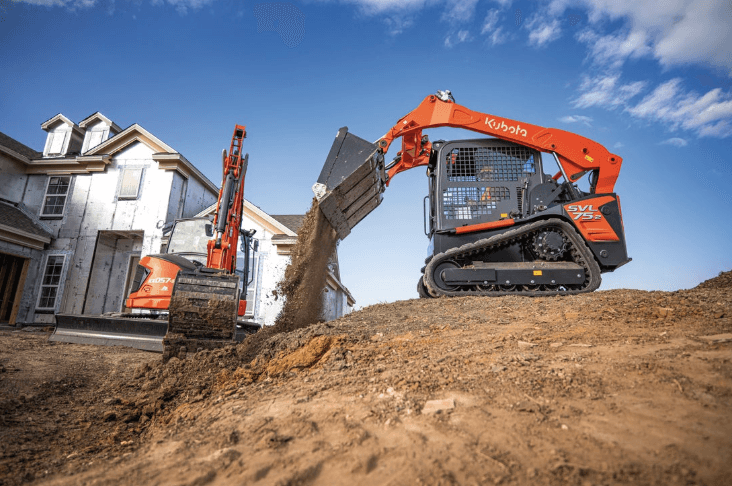 Track loader dumping dirt
