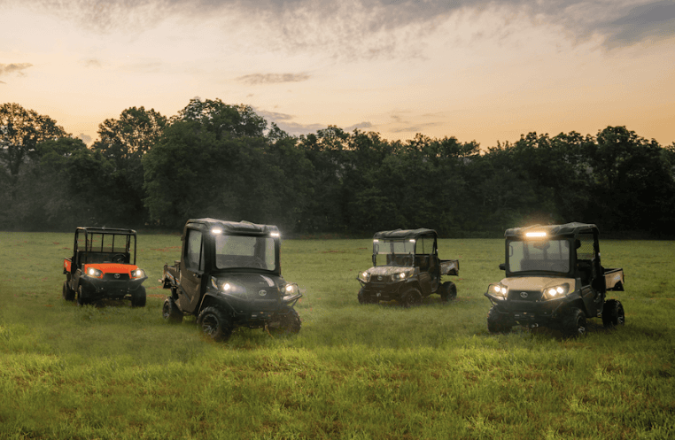 RTVs out in a field during sunset