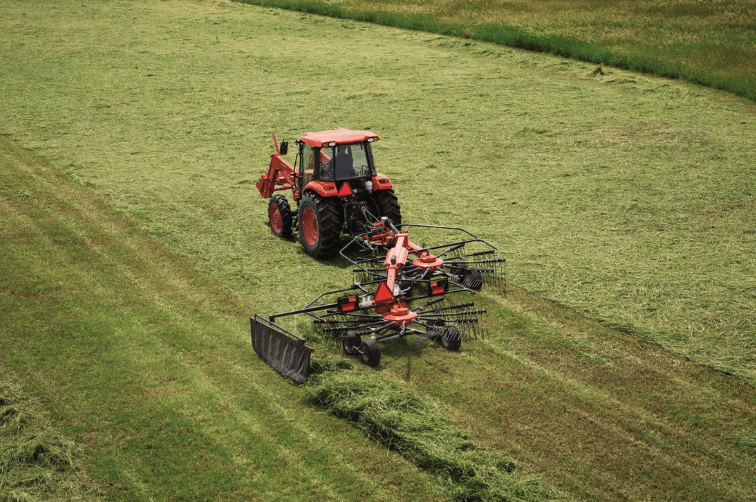 Tractor pulling a hay rotary rake