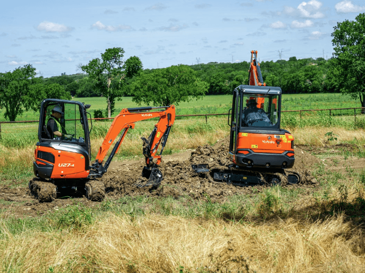Excavators in a field