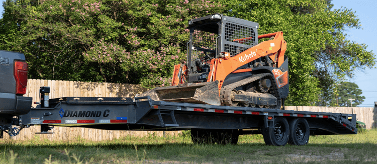 Skid steer on the back of a trailer