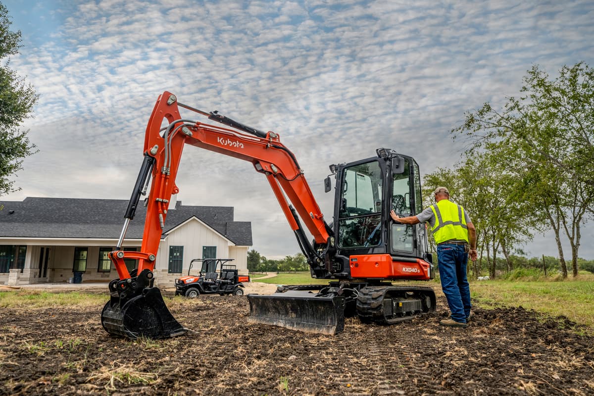 Kubota Compact Excavator in front of a new construction home